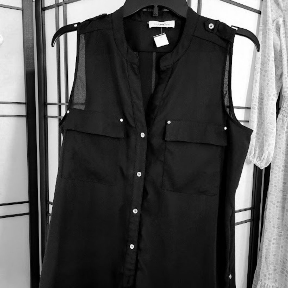 Black sleeveless button down blouse with extending length detail with buttons.